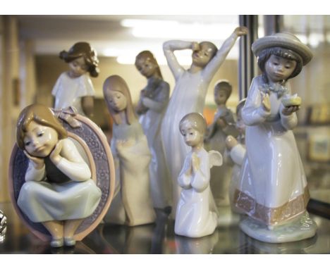 A group of assorted girl ornaments including 3 Lladro and 6 Nao.