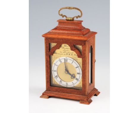 An early 20th Century Charles Frodsham miniature bracket clock, with oak body on four bracket feet with brass handle, the bra