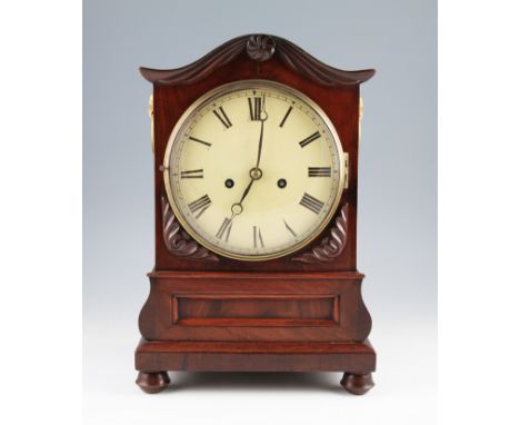 An Edwardian mahogany cased bracket clock with double fusee movement, the case having domed top with carved decoration on ste