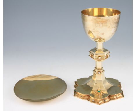 An early 20th Century silver gilt chalice, the plain circular tapering bowl leading to a hexagonal knopped stem, the central 