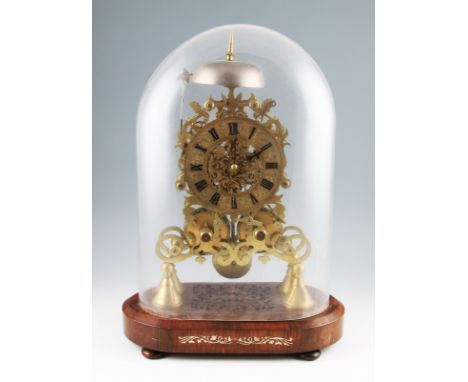 A 19th Century brass skeleton clock on mahogany stand with double fusee movement, the ornate design body having a brass circu