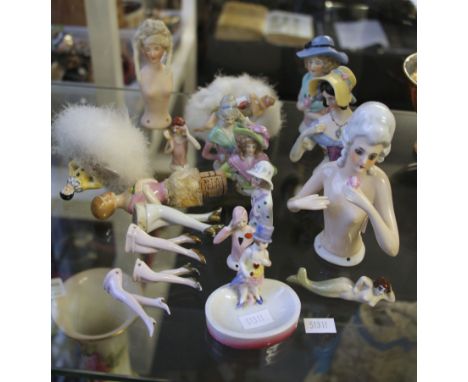 A collection of assorted early 20th Century ceramic half doll figures.