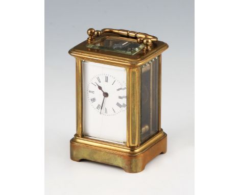 An early 20th Century miniature brass carriage clock housed in Moroccan leather travel case, the clock having bevelled edge g