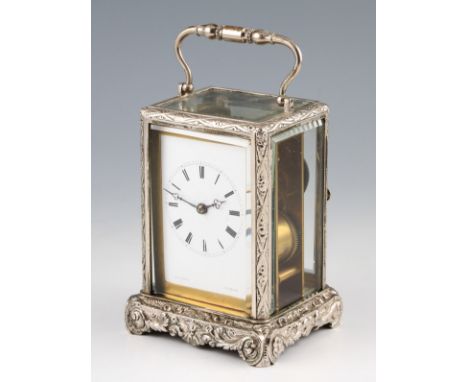 An early 20th Century French silver plated carriage clock with twin barrel movement, the body having patterned foot and frame