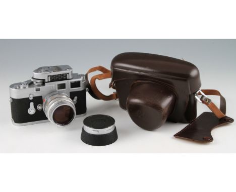 A Leica M3 R/F camera body fitted with Summilux 50mm F1.4 lens, exposure meter and lens hood in every ready case.