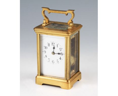 An early 20th Century French brass carriage clock with bevelled edge glass panels and top with twin barrel movement with stri