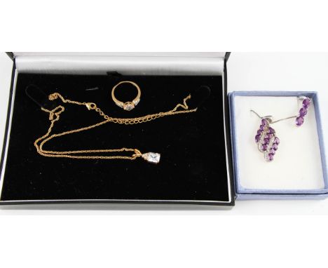 A cubic zirconia ring and pendant with chain, ring size M, ring stamped 925, together with two amethyst pendants, one with ch