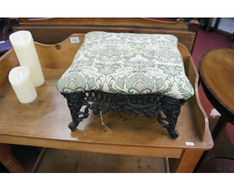 Cast iron and upholstered foot stool