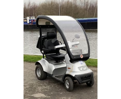 A T.G.A Breezes 4 wheeled mobility scooter complete with rear luggage box and detachable solid canopy and battery pack.Seems 