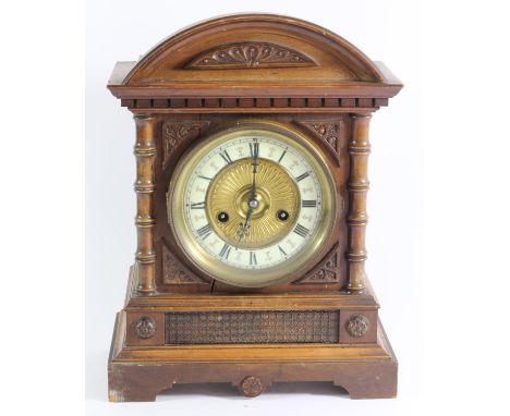 A German oak cased mantle clock by H.A.C Wurttemberg C.1900, case carved with curved pediment top and stepped base, 14 day mo