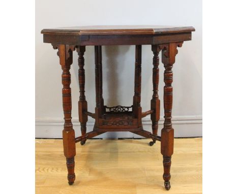 An Edwardian mahogany occasional table, octagonal shaped top, moulded edge with apron under, raised on turned legs with brass