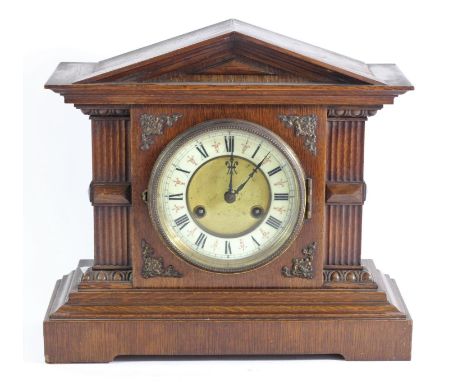 An early 20th Century oak cased mantle clock, enameled dial with roman numerals, movement striking the half and the hour - H: