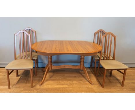 A extending dining table, light wood, with four upholstered dining chairs, together with a mid 20th century style display cab