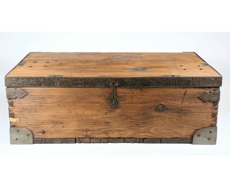 A rustic pine plank traveling trunk, with hinged lid, steel bound corners and edging, cast drop handles and clasp.L77cm H27cm