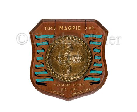 A WELL-PRESENTED SHIP'S BADGE FROM THE SLOOP H.M.S. MAGPIE, (1943) the 7in. badge cast in brass and mounted on a wooden shiel