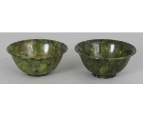 A SMALL NEAR PAIR OF 20TH CENTURY CHINESE SPINACH GREEN JADE-LIKE BOWLS, each 2.9in diameter & 1.25in high.