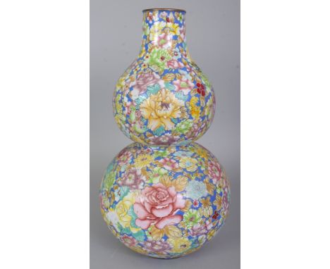 A CHINESE CANTON ENAMEL DOUBLE GOURD MILLEFLEUR VASE, decorated with a profusion of overlapping flowerheads and leafage, 13in