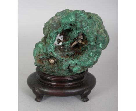 A CHINESE MALACHITE SCHOLAR'S BOULDER, together with a fixed wood stand, 5in high overall.