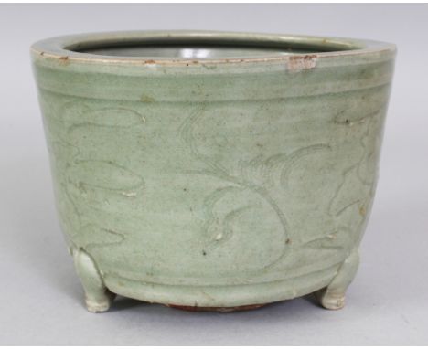 A CHINESE MING DYNASTY LONGQUAN CELADON TRIPOD CENSER, the slightly flaring sides incised beneath the glaze with stylised fol