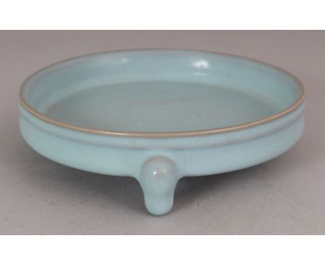 A SHALLOW CHINESE JUN WARE CERAMIC TRIPOD CENSER, the base with spur marks, 5.4in diameter at rim & 1.6in high.