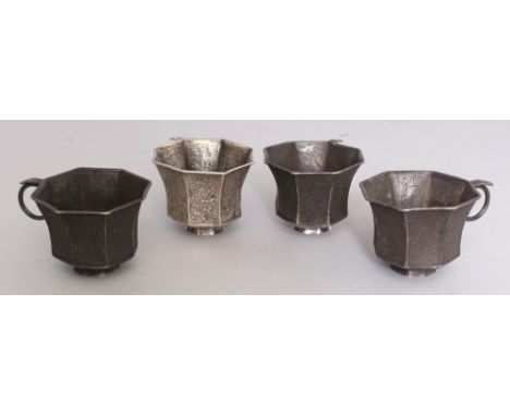 A SET OF FOUR GOOD QUALITY CHINESE TANG STYLE SILVER-METAL WINE CUPS, weighing 190gm in total, each cast and chased with pane