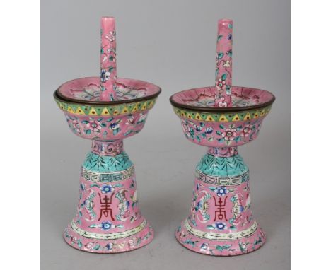 A PAIR OF 19TH CENTURY CHINESE PINK GROUND CANTON ENAMEL PRICKET JOSS STICK HOLDERS, with removable pans, 7.75in high.