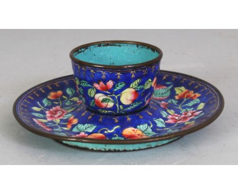 A 19TH CENTURY CHINESE CANTON ENAMEL CUP & CUP STAND, each piece decorated with vividly coloured foliage reserved on a vivid 
