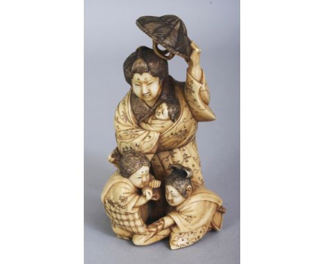 A GOOD QUALITY JAPANESE MEIJI PERIOD IVORY OKIMONO OF A MOTHER, holding a hat above her with one hand and clasping her baby w