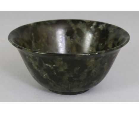 A 20TH CENTURY CHINESE MOTTLED DARK GREEN & BLACK JADE LIKE BOWL, 3.9in diameter & 1.8in high.