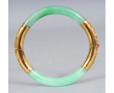 A CHINESE APPLE-GREEN JADE & GILT-METAL BANGLE, 2.9in diameter when closed.