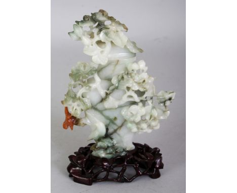 A CHINESE JADE VASE & COVER, together with a carved and pierced fitted wood stand, the predominantly white stone with green s