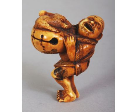 A JAPANESE MEIJI PERIOD STAINED IVORY NETSUKE OF A MONKEY PERFORMER, standing in an animated posture with his monkey clinging