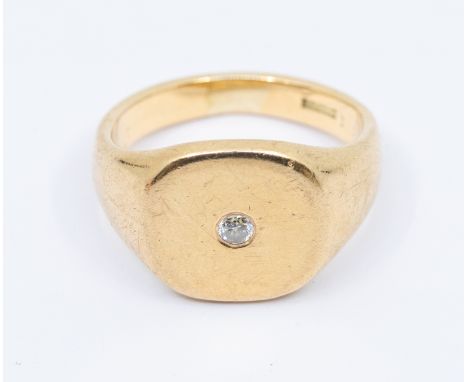 A gentleman's diamond set 9ct gold signet ring, comprising a cushion top, flush set with a small diamond, width of mount appr