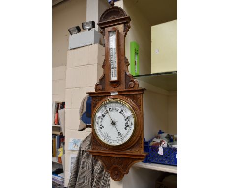 A 20th century oak cased carved barometer.