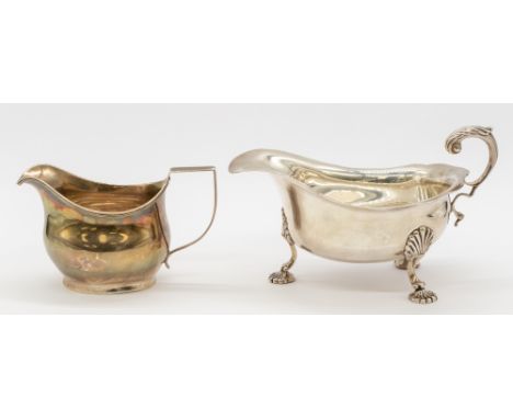 A George III silver helmet shaped cream jug, of simple form with ribbed edging, hallmarked London, 1810, makers mark slightly