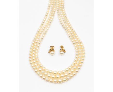 A three row cultured pearl necklace, comprising three graduated rows of round pearls, strung to a sapphire set 9ct white gold