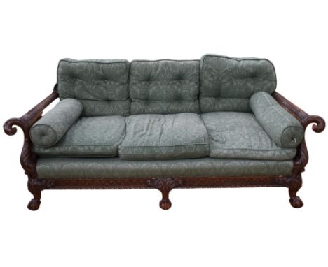 A bergere three-seater sofa, having ornate carved detail of eagle-headed arms, and foliate detail, on ball and claw feet,&nbs