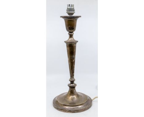 An Edwardian silver table lamp, urn shaped socle above tapering stem on circular base, hallmarked by Hawksworth, Eyre &amp; C