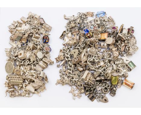 A collection of vintage silver charm bracelets, including various charms including London bus, Viking ship, fish, swans, mone