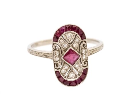 A ruby and diamond platinum Art Deco style ring, comprising an oval setting, the centre set with square checkerboard cut ruby