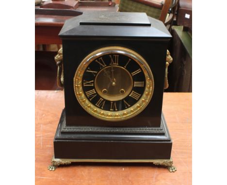 Large late 19th century French black slate mantle clock, eight day gilded detail to face, roman numerals, lion head handles.