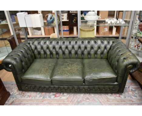 Late 20th century bottle green chesterfield three seater sofa with single tub chair and stool.