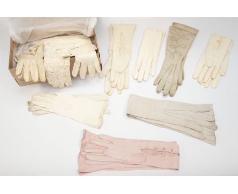 A collection of gloves in various materials and colours to include; A pair of early 19th century Regency knitted lace gloves,