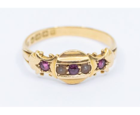 An Edwardian ruby and pearl ring, set with three round mixed cut rubies and alternate pearl set accents, width approx 7mm, si