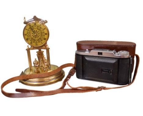 A mid 20th century domed Anniversary clock and a vintage camera