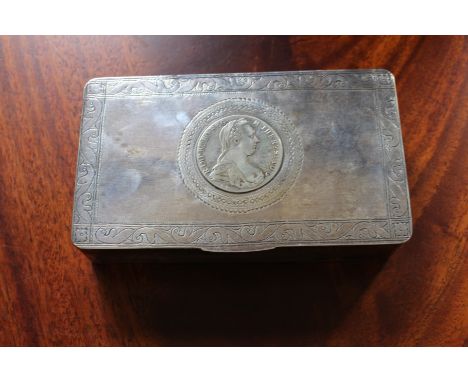 A white metal rectangular box with hinged cover and engraved border and inset with Marie Theresa Taler, 15.5cm wide, along wi