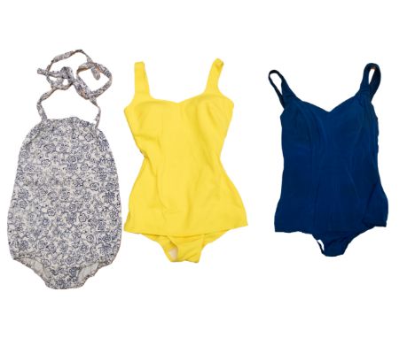 A collection of swimsuits to include: an early 1950s elasticated/gathered swimsuit in cream with navy blue floral motif print