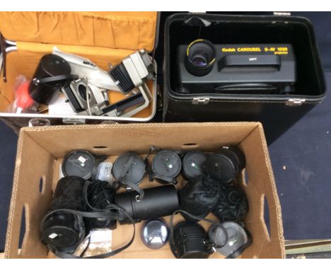A collection of mostly Olympus camera lenses, cased camera and slide projector.