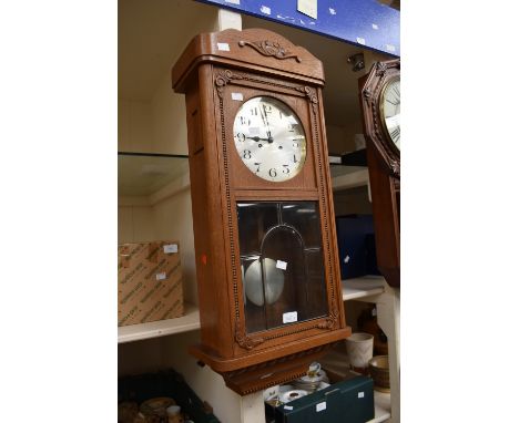 1930s light oak wall-hanging 8-day clock, along with a carved oak barometer