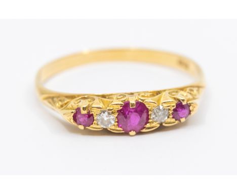 A Victorian ruby and diamond 18ct gold ring, comprising three graduated round mixed cut rubies the largest approx 3.5mm, two 